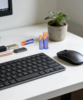 Combo Pack Of 24 AA And AAA Batteries 12 Each 1.5V Alkaline Heavy Duty on desk with keyboard and mouse