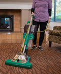 Commercial Upright Vacuum With ProCup Comfort Grip, 870W Motor, 16-Inch Cleaning Path in use on carpeted floor