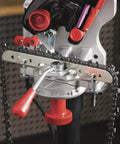 Close-up of a Professional Compact 120-Volt Bench Grinder And Universal Saw Chain Sharpener mounted with a saw chain for woodworking.