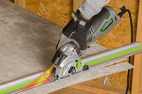 5.8 Amp Compact Circular Saw Kit With Laser Guide cutting wood in workshop with one hand grip and miter base system in action