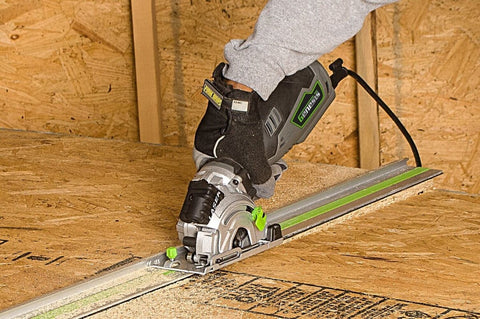 5.8 Amp Compact Circular Saw Kit With Laser Guide in action cutting wood with precision miter base system, one hand grip visible