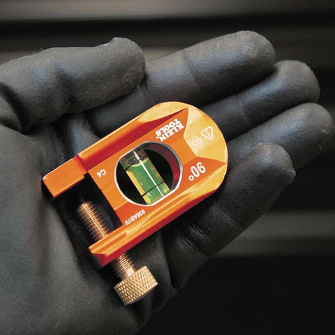 Compact 2.5 inch no-dog conduit bending level with 1 vial and ACCU-BEND design held in gloved hand