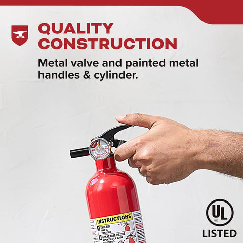 Hand holding multi purpose fire extinguisher 1A10BC for home office dorm and residential use, all metal construction.