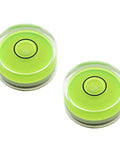 Two compact green round mini spirit levels with clear acrylic housings for precise bubble readings and alignment in tiny projects.