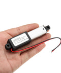 Compact 12V electric linear actuator with a 2 inch stroke, IP54 waterproof, shown on a hand for scale, ideal for tight spaces.