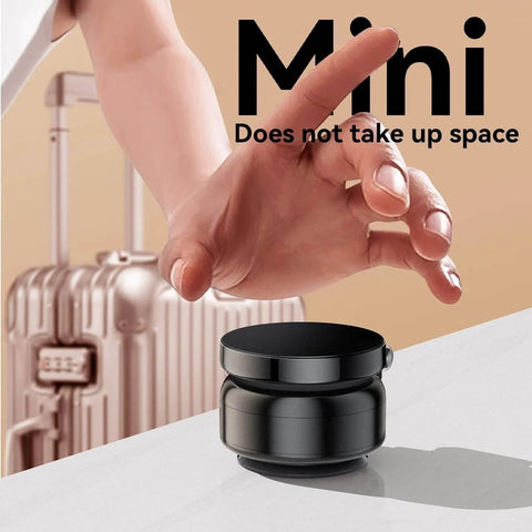 Hand reaching for mini Magnetic Phone Holder With Vacuum Grip Technology on surface, luggage in background.