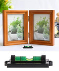 Green bubble spirit level beside two picture frames for 4 Pack RV Levelers With Screws Bubble Spirit Level For Travel Trailer Motorhome Camping Compact 60mm Long Levelers 25mm Wide Heavy Duty Leveling Tools For Quick On The Go Leveling