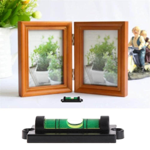 Green bubble spirit level beside two picture frames for 4 Pack RV Levelers With Screws Bubble Spirit Level For Travel Trailer Motorhome Camping Compact 60mm Long Levelers 25mm Wide Heavy Duty Leveling Tools For Quick On The Go Leveling