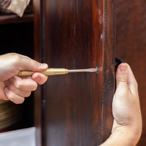 Person using a screwdriver from the 5 In 1 Hammer With Built In Screwdrivers Chrome Plated To Resist Rust Lightweight Compact Multitool