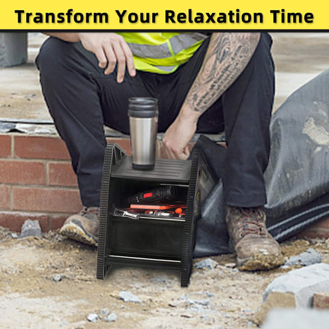 Worker seated beside a black storage step with cup holder, storing tools and coffee on a construction site with equipment.