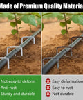 Comparison of heavy duty galvanized landscape staples and rust-prone stakes securing a hose in soil