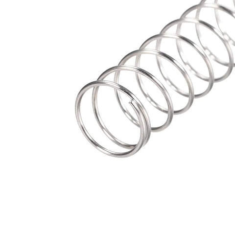 Close-up of a 304 Stainless Steel compression spring for DIY projects, 15mm outer diameter, 1mm wire size, silver tone, 60mm free length