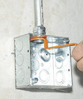 Using the Conduit Locknut Wrench Set With Opposing Offset Bends For Tight Spaces One Half Inch, Three Quarter Inch, And One Inch Sizes Three Piece Magnetic Storage Patent Pending on an electrical box
