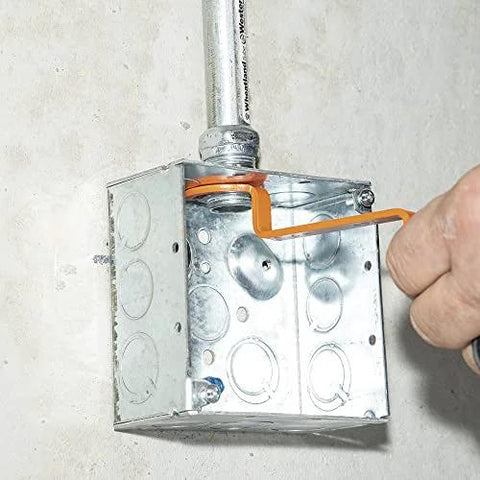 Using the Conduit Locknut Wrench Set With Opposing Offset Bends For Tight Spaces One Half Inch, Three Quarter Inch, And One Inch Sizes Three Piece Magnetic Storage Patent Pending on an electrical box