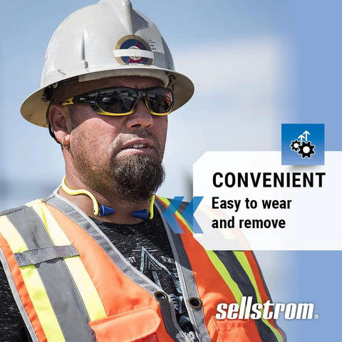 Construction worker wearing reusable banded earplugs for work hearing protection with neck cord, high visibility green and blue.