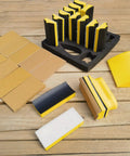 16 Contoured Sander Blocks With 40 Sheet Sandpaper For Woodworking Moldings displayed on a wooden surface