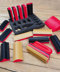 16 Piece Contoured Sanding Block Set With Interchangeable Hook And Loop Shapes on wooden surface