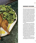 Open cookbook page showing smoked chicken recipe with greens, from Texas Style Live Fire Grilling And Smoking At Home A Cookbook.
