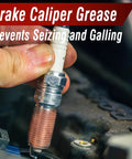 Image of a hand applying Keze Copper Anti Seize Thread Lubricant Grease to an automotive spark plug to prevent rust and corrosion.