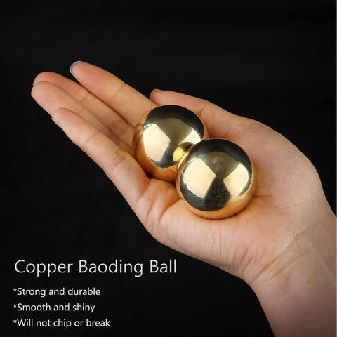 Hand holding Tianigo Copper Baoding Balls Set, 1.57 Inches Chinese Health Balls, stress relief hand massage balls for therapy.
