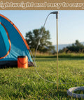 Grounding rod with 40ft wire connects your body to the earth, shown set up in a grassy field with a camping tent in the background.