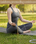 Woman meditating outdoors using a grounding rod with 40ft wire connects your body to the earth great for earthing sheets mats pillowcases and pads
