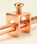 Close-up of copper clamp with attached wire, part of the Copper Grounding Rod With Attached Wire Clamp For Antennas And Satellite Dishes