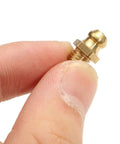 Close-up of a Premium Copper Taper Thread Grease Zerk Nipple Fitting Straight 1/4-28 SAE-LT held between fingers.