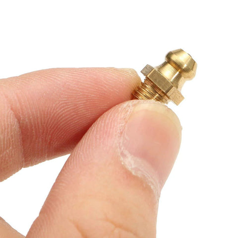Close-up of a Premium Copper Taper Thread Grease Zerk Nipple Fitting Straight 1/4-28 SAE-LT held between fingers.