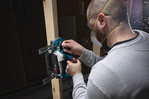 Man using Renewed 120V corded planer delivers precise three and a quarter inch capacity for flattening and smoothing boards, 16,500 RPM, 6.5A performance, and includes stand with a dual-guide fence for accurate surfacing, door trimming, and stock prep in shops.
