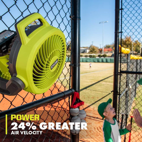 Cordless 18V Hybrid Whisper Series 7.5 Inch Fan Tool Only Bare Tool For Lawn Care Pros installed on fence at baseball field.