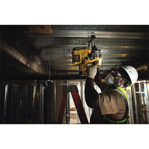 Worker using 20V MAX SDS rotary hammer overhead in construction site, featuring brushless motor and fatigue-reduced bare-tool design.