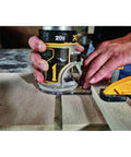 Person using 20V Max XR Cordless Brushless Router With Variable Speed Dual LEDs And Precise Depth Adjustment on wood surface