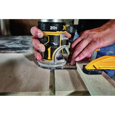 Person using 20V Max XR Cordless Brushless Router With Variable Speed Dual LEDs And Precise Depth Adjustment on wood surface