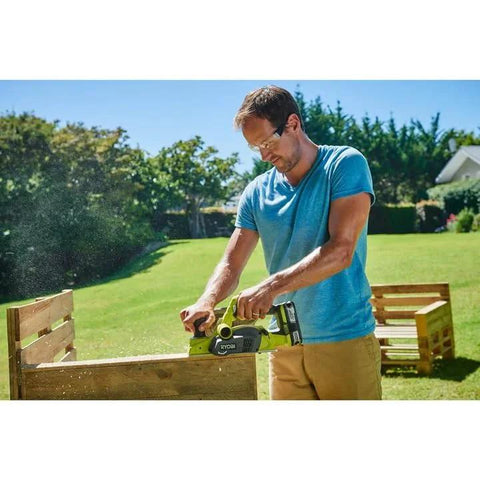 Person using Cordless 18V Planer with a compact 3-1/4 inch width and included dust bag for outdoor edge work on wood