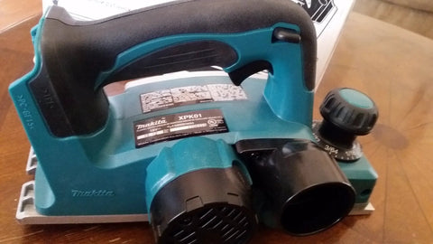 18V cordless planer tool, front view, showing handle and adjustment knob, ideal for trimming doors and cabinet edges on-site.