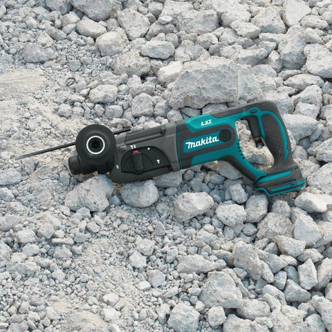 Cordless SDS-Plus 7/8 inch rotary hammer on concrete rocks, showing tool-only design and 18V LXT battery compatibility.