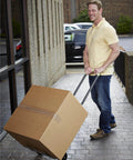 Person using COSCO Shifter Multi-Position Folding Hand Truck and Cart, 300 lb. Weight Capacity, Green, 12222PBG1E to move a box
