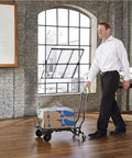 Person using the ✝️ COSCO Shifter Multi-Position Folding Hand Truck and Cart, 300 lb. Weight Capacity, Green, 12222PBG1E indoors