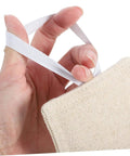 Close-up of hand holding beige cotton door damper and slam silencer set, reduces noise, prevents slams, protects walls and fingers.
