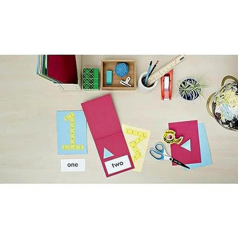 Double Sided Tape For Gift Wrapping And Crafts, 0.50 Inch By 1296 Inch Roll on desk with stationery, globe, and cards