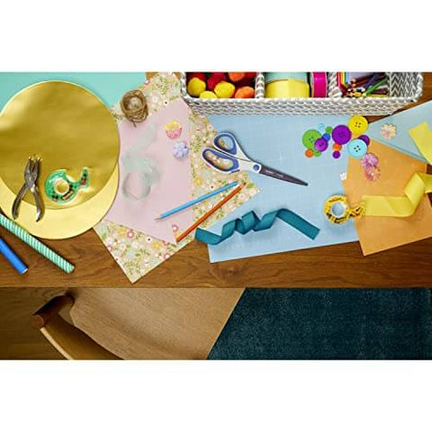 Craft table with supplies including scissors, ribbons, paper, and Double Sided Tape For Gift Wrapping And Crafts, 0.50 Inch By 1296 Inch Roll, Two Refill Rolls, Mess Free Permanent Adhesive For Holiday Gift Wrap And Scrapbooking Alternative, Office And School Supplies.