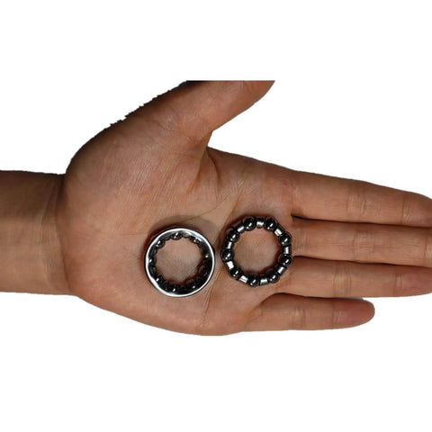Hand holding Bike Ball Crank Bearing Retainer One Quarter Inch With Nine Balls Four Pieces Bottom Bracket Bearings for kids' bikes.