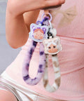 Crybaby Wild But Cutie Series Phone Charm Blind Box Wrist Strap Keychain, fuzzy straps with cute character designs, hanging from hand