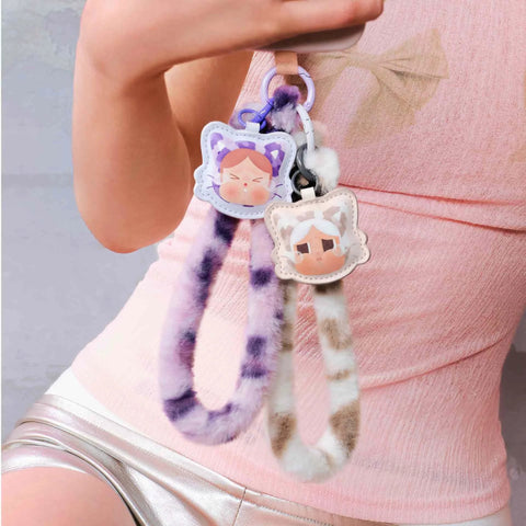 Crybaby Wild But Cutie Series Phone Charm Blind Box Wrist Strap Keychain, fuzzy straps with cute character designs, hanging from hand