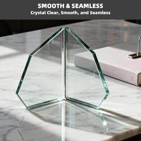 Geometric clear glass sculpture on marble table under sunlight
