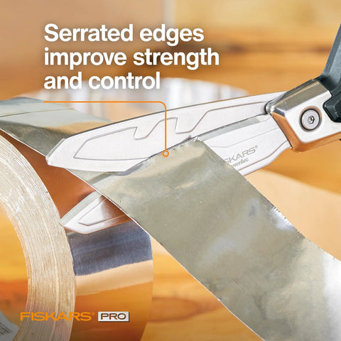 PowerArc Heavy Duty Shop Shears cutting tape, showcasing curved serrated blades and extended tang for construction use.