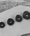 100 Pieces Black Plastic Curved Washers Set For Round Tubes M6 And M8 With PE Spacer Sleeves shown with washers on marble surface