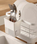Cutlery Drying Rack - Utensil Drainer with forks and spoons hanging on a dish rack near the sink