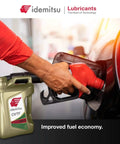 Person refueling car with Idemitsu CVT Type N NS2 Transmission Fluid for Nissan, bottle displayed, focus on fuel economy.